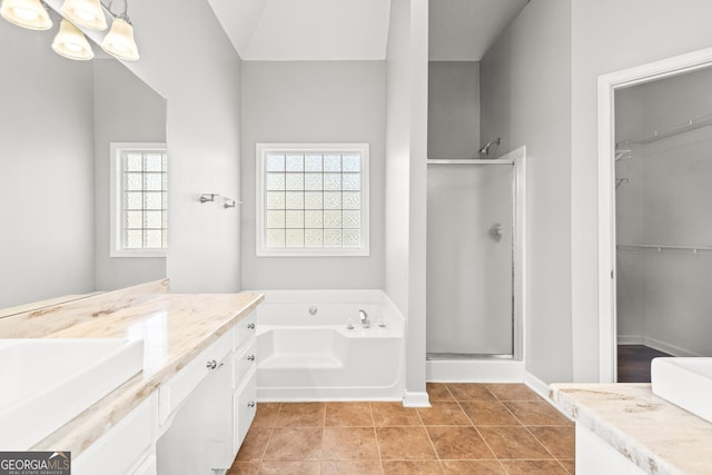 bathroom featuring vanity, tile patterned floors, and separate shower and tub