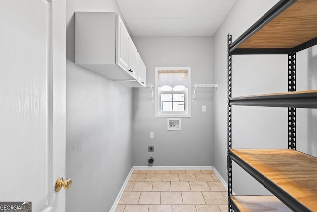 laundry room with electric dryer hookup, cabinets, a textured ceiling, and hookup for a washing machine