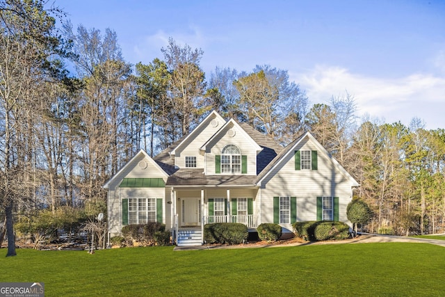 front of property with covered porch and a front yard