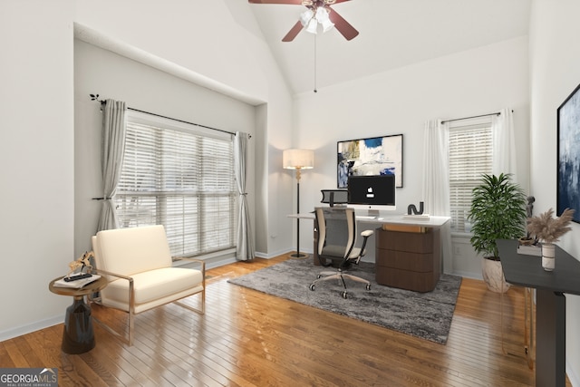 office area featuring hardwood / wood-style flooring, high vaulted ceiling, and ceiling fan