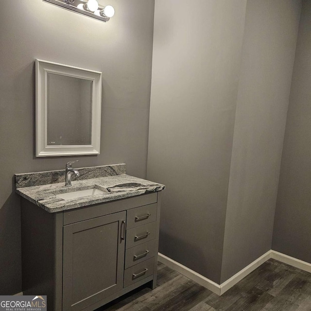 bathroom with hardwood / wood-style floors and vanity