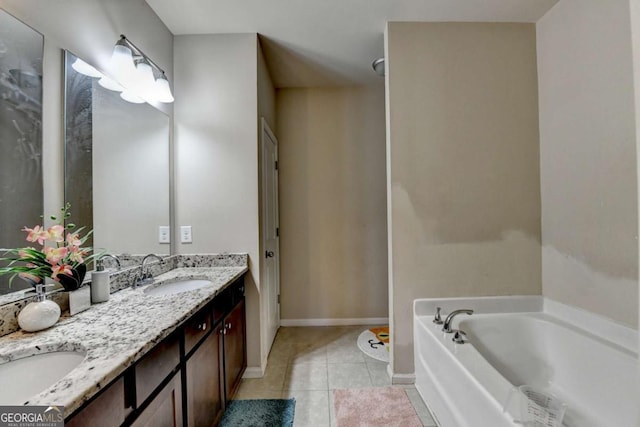 bathroom with tile patterned flooring, vanity, and a bath