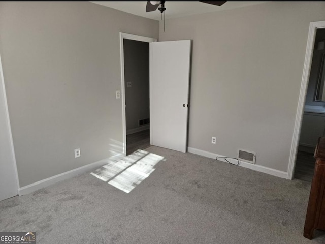 unfurnished bedroom featuring ceiling fan and light carpet