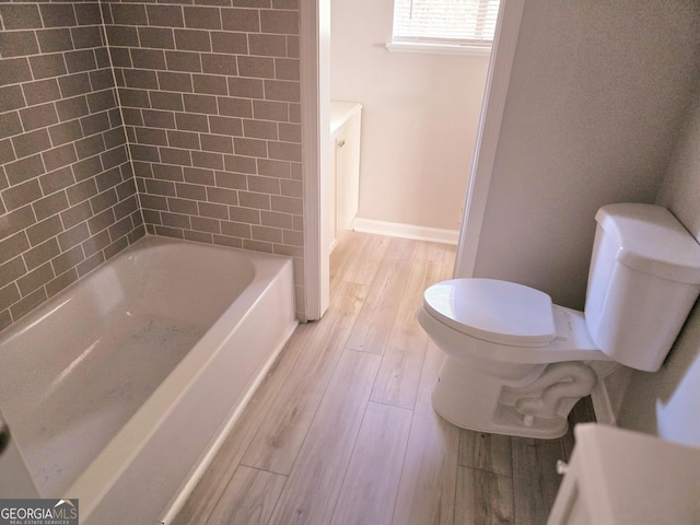 bathroom featuring toilet, shower / bath combination, and hardwood / wood-style flooring