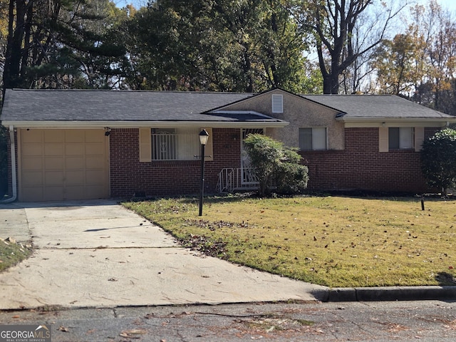 single story home featuring a garage and a front yard