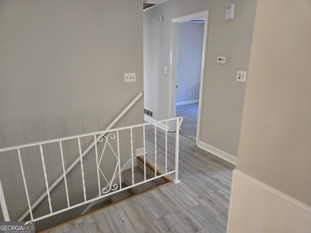 staircase featuring wood-type flooring