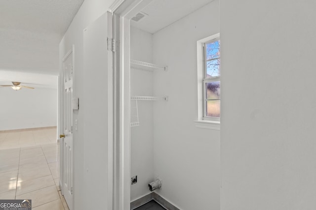 laundry room with ceiling fan and light tile patterned flooring