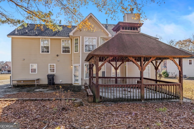 rear view of house featuring a gazebo