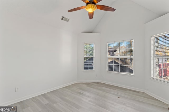 unfurnished room featuring ceiling fan, light hardwood / wood-style floors, plenty of natural light, and high vaulted ceiling