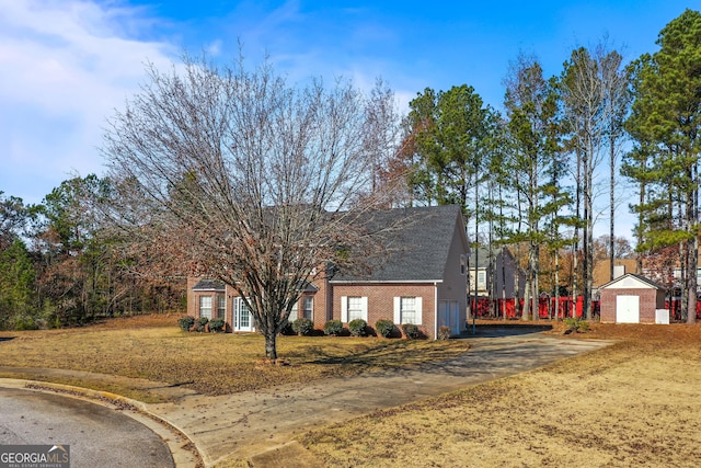 view of front of property featuring a garage and an outdoor structure