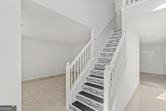 stairway with tile patterned flooring