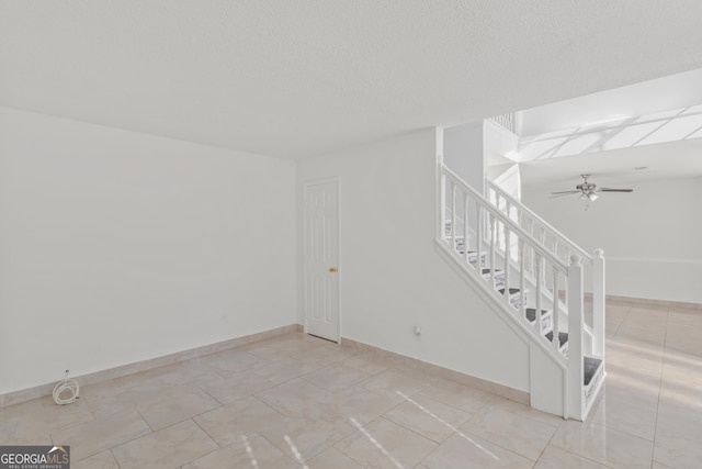 interior space featuring a textured ceiling and ceiling fan