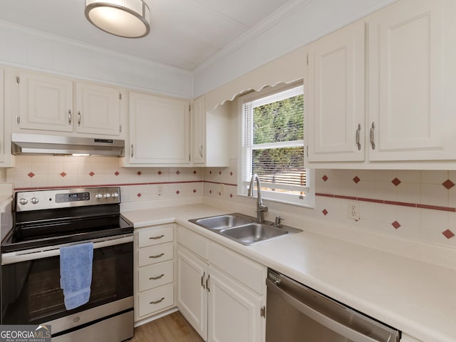 kitchen featuring white cabinetry, sink, stainless steel appliances, backsplash, and crown molding