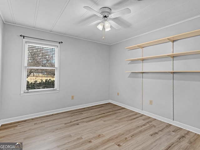 empty room featuring ceiling fan, ornamental molding, and light hardwood / wood-style flooring