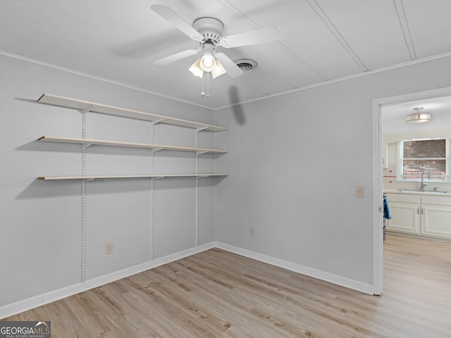 spare room featuring ceiling fan, sink, crown molding, and light hardwood / wood-style flooring