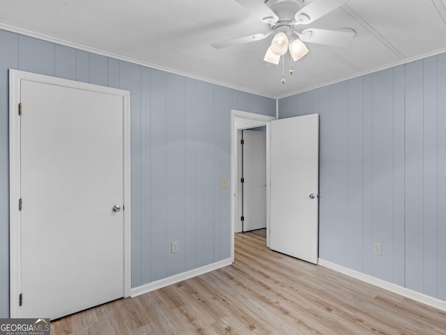 unfurnished bedroom with ceiling fan, light hardwood / wood-style floors, and ornamental molding