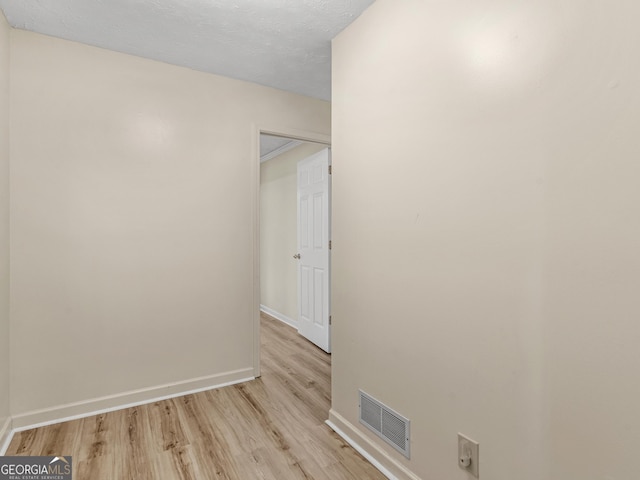 empty room with light hardwood / wood-style flooring