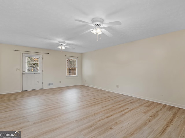 unfurnished room featuring ceiling fan and light hardwood / wood-style floors