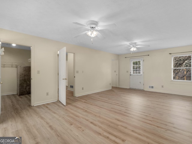 spare room featuring ceiling fan and light hardwood / wood-style flooring