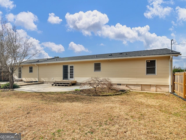 rear view of property with a yard and a patio