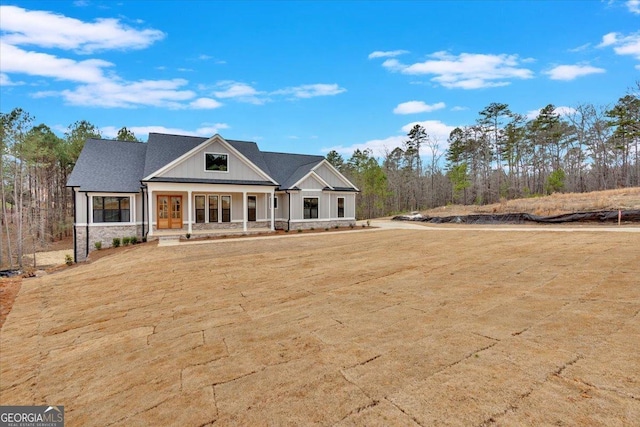 view of front of home with a front yard and covered porch