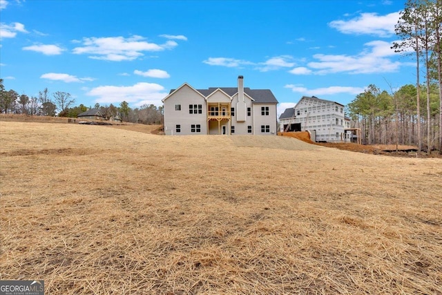 back of house featuring a yard