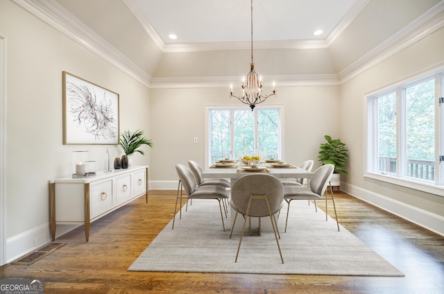 dining area with a notable chandelier, dark hardwood / wood-style flooring, and ornamental molding