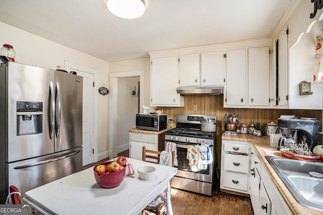 kitchen with white cabinets, dark hardwood / wood-style floors, sink, and stainless steel appliances