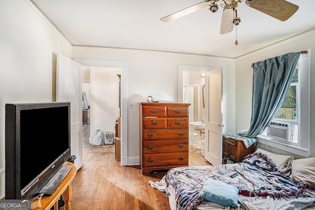 bedroom with connected bathroom, ceiling fan, crown molding, cooling unit, and light wood-type flooring