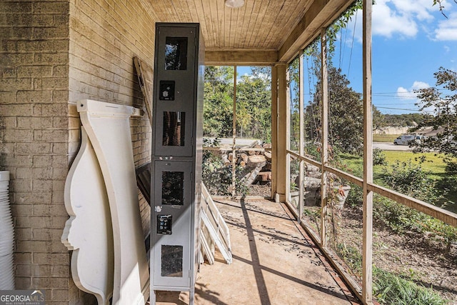 unfurnished sunroom with wood ceiling