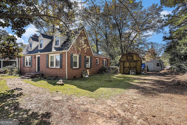 view of side of home featuring a shed and a yard