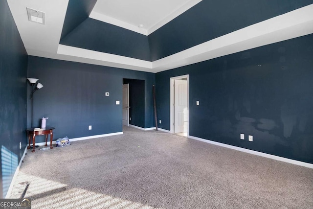 unfurnished room featuring carpet and a towering ceiling