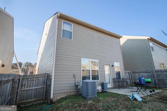 rear view of property with cooling unit and a patio area