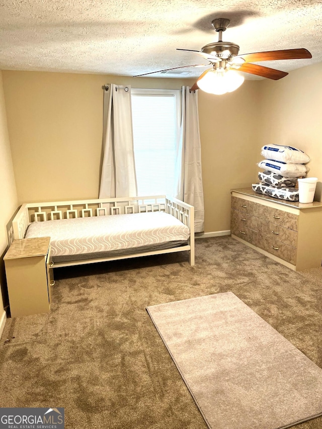 unfurnished bedroom featuring carpet flooring, ceiling fan, and a textured ceiling