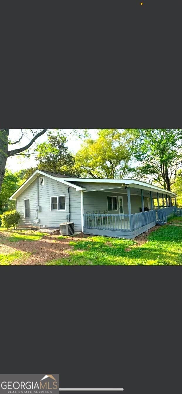 single story home with a front yard and a porch