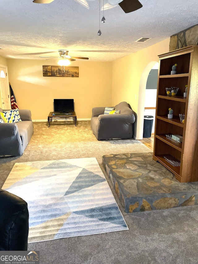 carpeted living room with a textured ceiling