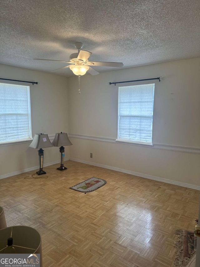 workout area with light parquet flooring and ceiling fan