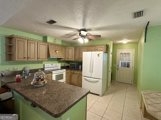 kitchen with a textured ceiling, kitchen peninsula, light tile patterned floors, and white appliances