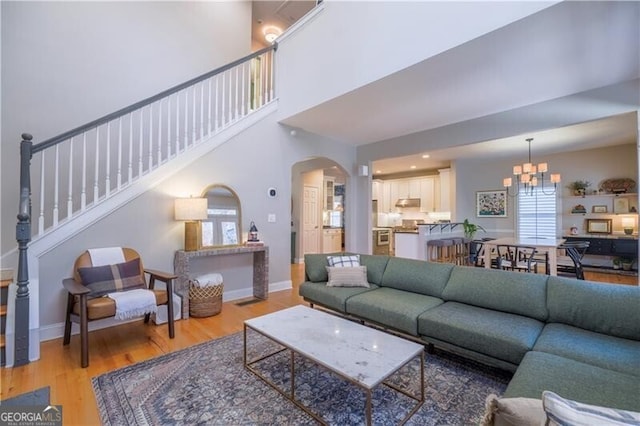 living room with hardwood / wood-style floors and an inviting chandelier