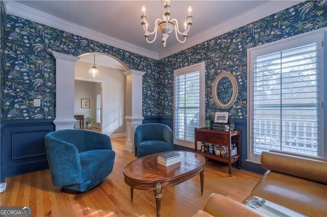 sitting room featuring plenty of natural light, light hardwood / wood-style flooring, and decorative columns