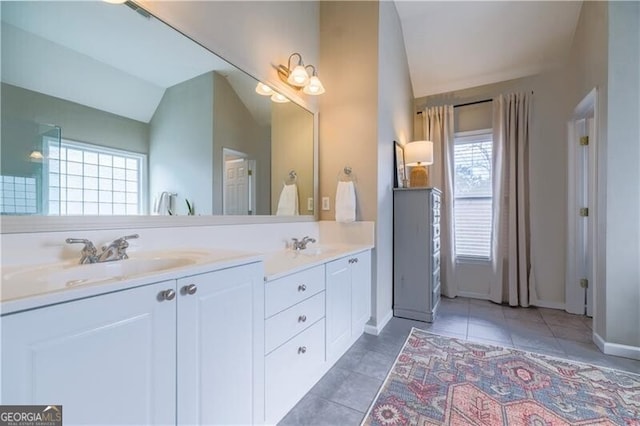 bathroom featuring tile patterned flooring, vanity, and lofted ceiling