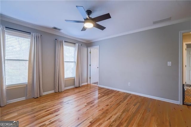 empty room with light hardwood / wood-style flooring, ceiling fan, and crown molding