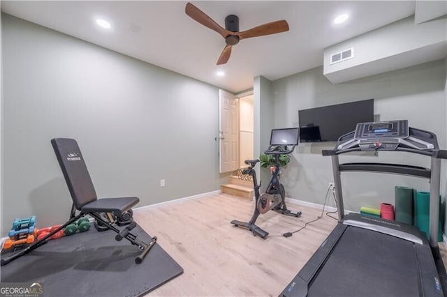 workout area featuring ceiling fan and hardwood / wood-style flooring