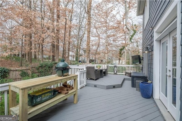 wooden deck featuring a grill