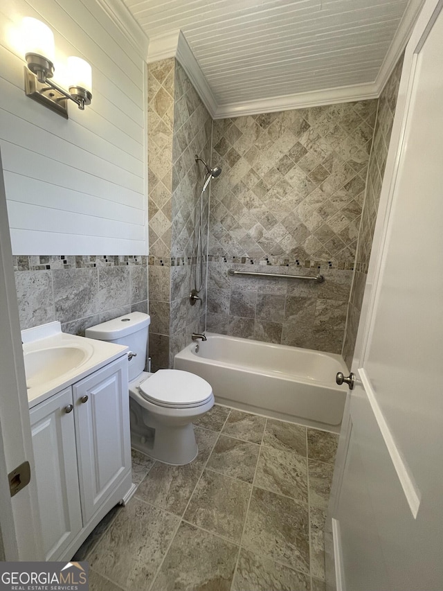 full bathroom featuring vanity, ornamental molding, tiled shower / bath, and tile walls