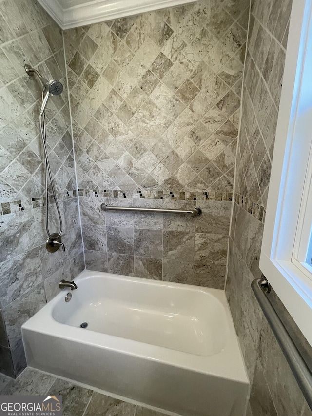 bathroom with tiled shower / bath combo and crown molding