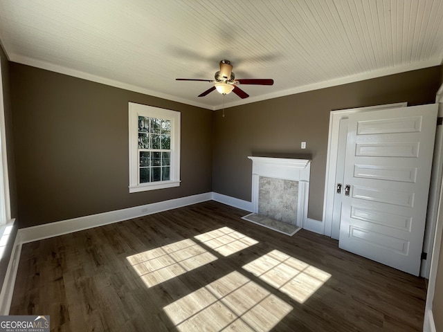 interior space with a fireplace, dark hardwood / wood-style floors, ceiling fan, and crown molding