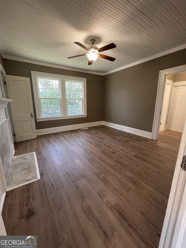 unfurnished bedroom with ceiling fan, dark hardwood / wood-style floors, and crown molding