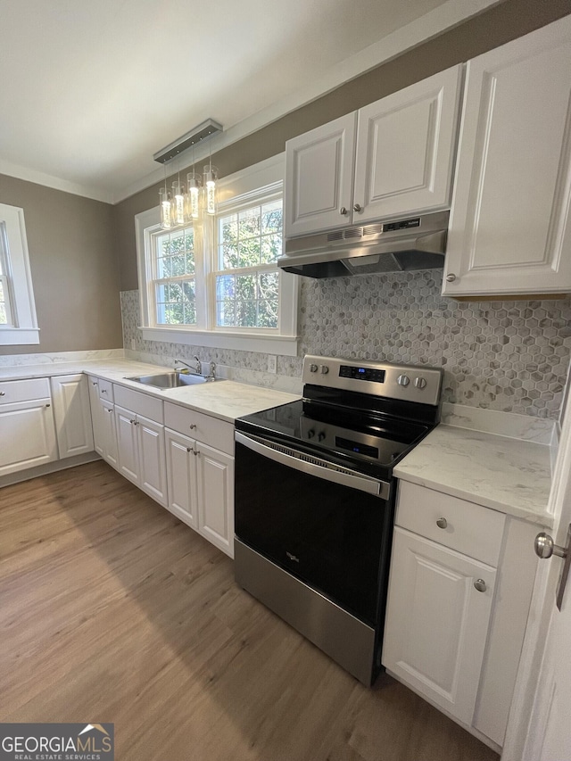 kitchen with stainless steel electric range oven, sink, light hardwood / wood-style flooring, crown molding, and white cabinets