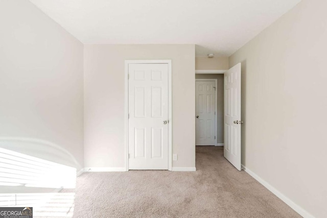 unfurnished bedroom with light carpet